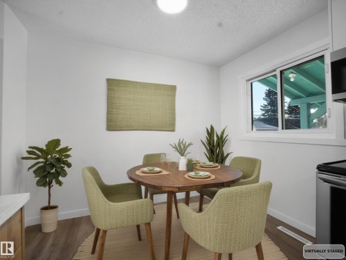 Dining space with a textured ceiling and dark wood-style floors - 10329 132 Avenue, Edmonton, AB - Indoor Photo Showing Dining Room
