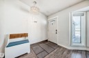 Foyer entrance featuring wood finish floors and a chandelier - 7011 190B Street, Edmonton, AB  - Indoor Photo Showing Other Room 