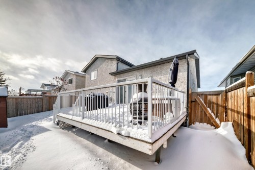 Back of house with a fenced backyard, a wooden deck, a gate, and stucco siding - 7011 190B Street, Edmonton, AB - Outdoor With Deck Patio Veranda With Exterior