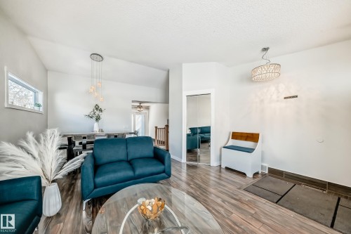 Living area with wood finished floors, ceiling fan, and a textured ceiling - 7011 190B Street, Edmonton, AB - Indoor Photo Showing Living Room