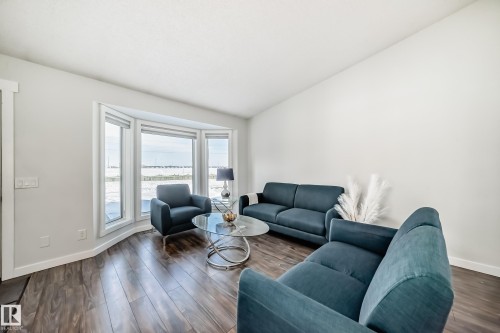 Living area with dark wood-type flooring - 7011 190B Street, Edmonton, AB - Indoor Photo Showing Living Room
