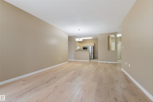 Unfurnished living room with light wood finished floors and arched walkways - 232 15499 Castle Downs Road, Edmonton, AB - Indoor Photo Showing Other Room