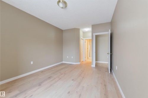 Spare room with baseboards and light wood-type flooring - 232 15499 Castle Downs Road, Edmonton, AB - Indoor Photo Showing Other Room