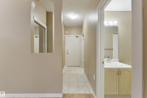 Hallway with a textured ceiling and light wood finished floors - 232 15499 Castle Downs Road, Edmonton, AB - Indoor