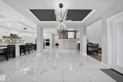 Living area with a raised ceiling and suspended lighting - 4406 Triomphe Close, Beaumont, AB - Indoor