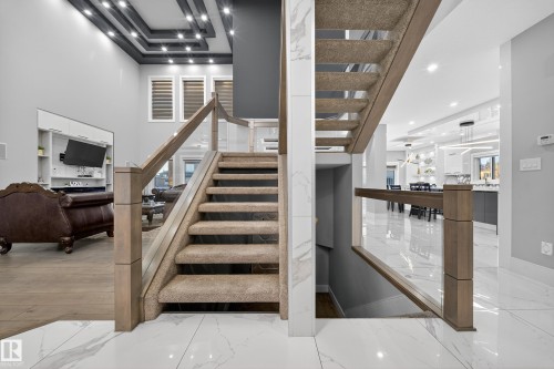 Staircase with recessed lighting and marble tiled flooring - 4406 Triomphe Close, Beaumont, AB - Indoor Photo Showing Other Room