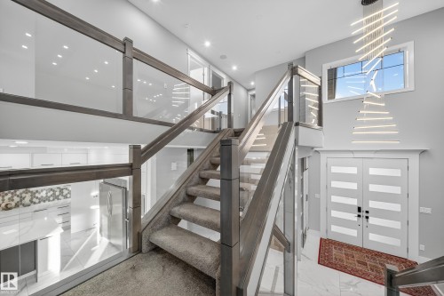 Staircase with marble finish flooring and a high ceiling - 4406 Triomphe Close, Beaumont, AB - Indoor Photo Showing Other Room