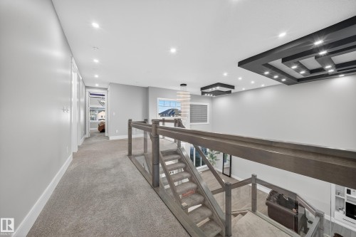 Hall with an upstairs landing, recessed lighting, and light carpet - 4406 Triomphe Close, Beaumont, AB - Indoor Photo Showing Other Room