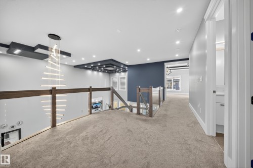 Hallway with an upstairs landing, carpet floors, and recessed lighting - 4406 Triomphe Close, Beaumont, AB - Indoor Photo Showing Other Room