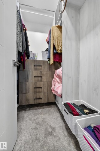 Walk in closet featuring light colored carpet - 4406 Triomphe Close, Beaumont, AB - Indoor With Storage