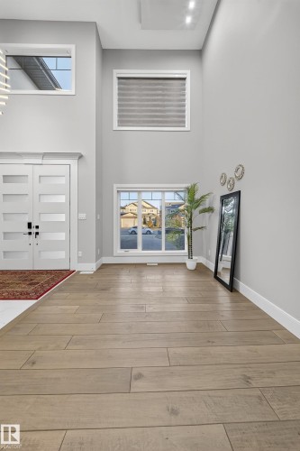 Entryway featuring plenty of natural light, a high ceiling, and light wood-style flooring - 4406 Triomphe Close, Beaumont, AB - Indoor Photo Showing Other Room