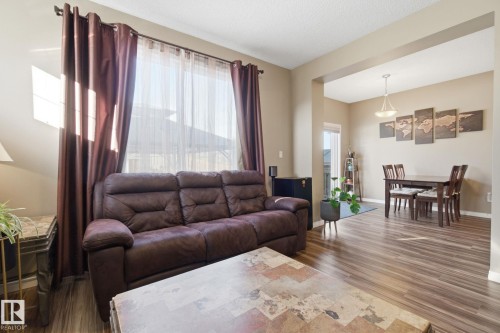 Living area featuring dark wood-style floors and baseboards - 3087 Arthurs Crescent, Edmonton, AB - Indoor Photo Showing Living Room