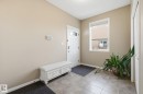 Entrance foyer featuring baseboards and light tile patterned floors - 3087 Arthurs Crescent, Edmonton, AB  - Indoor Photo Showing Other Room 