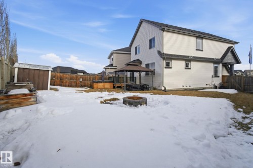 Snow covered back of property featuring a gazebo, an outdoor fire pit, a shed, a fenced backyard, and a patio area - 3087 Arthurs Crescent, Edmonton, AB - Outdoor