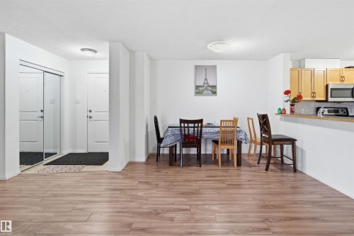 Dining room with light wood-type flooring and a textured ceiling - 407 2305 35A Avenue, Edmonton, AB - Indoor