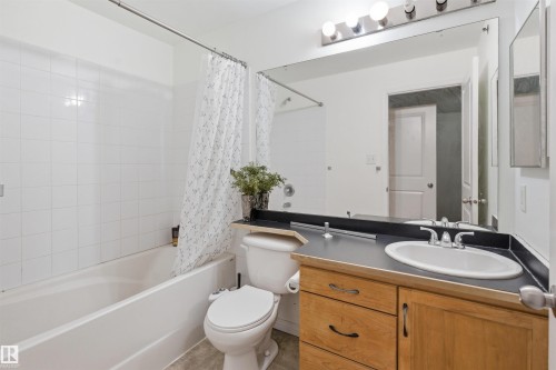 Full bath featuring vanity and shower / bathtub combination with curtain - 407 2305 35A Avenue, Edmonton, AB - Indoor Photo Showing Bathroom