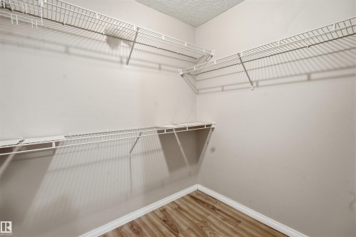 Walk in closet with light wood-type flooring - 407 2305 35A Avenue, Edmonton, AB - Indoor With Storage