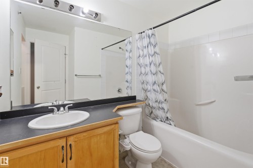 Full bathroom featuring vanity and shower / tub combo with curtain - 407 2305 35A Avenue, Edmonton, AB - Indoor Photo Showing Bathroom