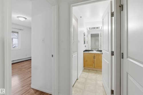 Corridor with a baseboard radiator and washer / dryer - 407 2305 35A Avenue, Edmonton, AB - Indoor Photo Showing Other Room