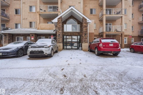 Snow covered building featuring a view of apartment building / complex and uncovered parking - 407 2305 35A Avenue, Edmonton, AB - Outdoor