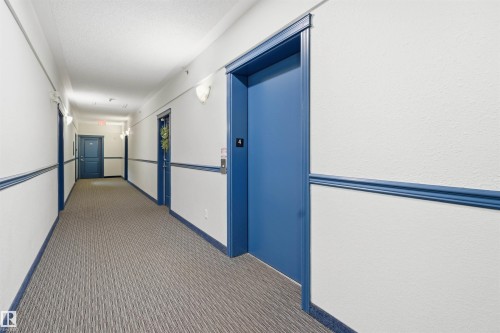 Corridor with elevator and carpet - 407 2305 35A Avenue, Edmonton, AB - Indoor Photo Showing Other Room