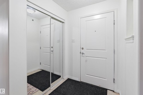 Doorway featuring a textured ceiling and tile patterned floors - 407 2305 35A Avenue, Edmonton, AB - Indoor Photo Showing Other Room