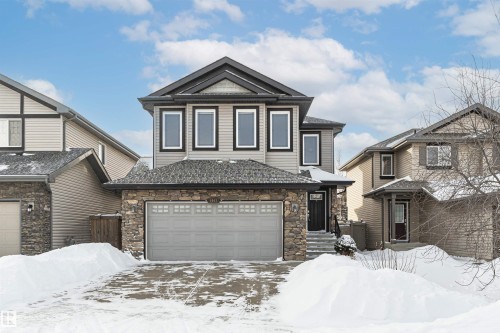 View of front of home featuring stone siding and a garage - 6963 19A Avenue, Edmonton, AB - Outdoor With Facade