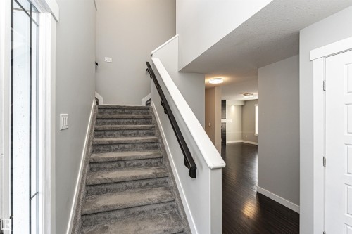 Stairway with hardwood / wood-style floors and a high ceiling - 6963 19A Avenue, Edmonton, AB - Indoor Photo Showing Other Room