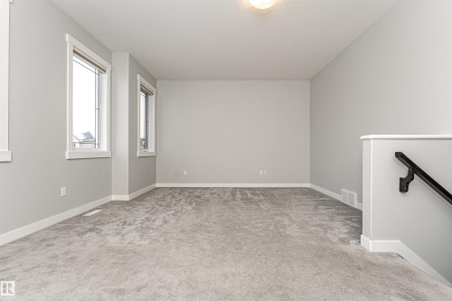 Unfurnished room with light carpet and baseboards - 6963 19A Avenue, Edmonton, AB - Indoor Photo Showing Other Room