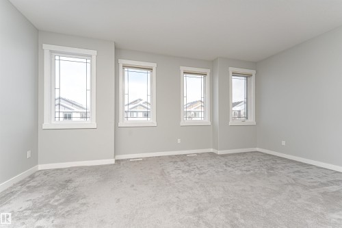 Empty room with light carpet and baseboards - 6963 19A Avenue, Edmonton, AB - Indoor Photo Showing Other Room