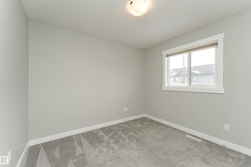 Unfurnished room with baseboards and carpet floors - 6963 19A Avenue, Edmonton, AB - Indoor Photo Showing Other Room