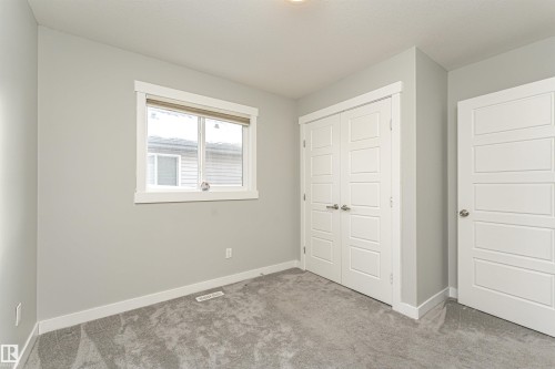 Unfurnished bedroom featuring light colored carpet and a closet - 6963 19A Avenue, Edmonton, AB - Indoor Photo Showing Other Room