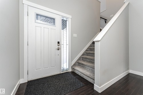 Foyer with baseboards and dark wood finished floors - 6963 19A Avenue, Edmonton, AB - Indoor Photo Showing Other Room
