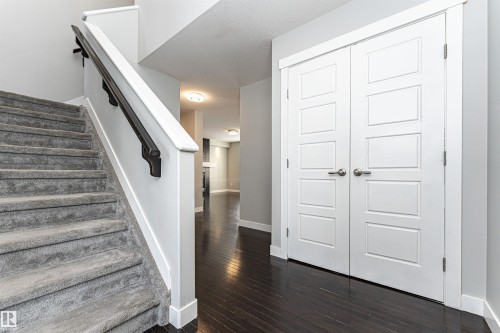 Staircase with baseboards and wood-type flooring - 6963 19A Avenue, Edmonton, AB - Indoor Photo Showing Other Room