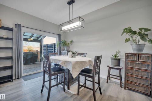 Dining area with light wood-style flooring and baseboards - 157 Larch Crescent, Leduc, AB - Indoor Photo Showing Dining Room