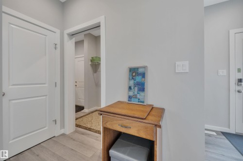 Hallway with light wood-style flooring and baseboards - 157 Larch Crescent, Leduc, AB - Indoor Photo Showing Other Room