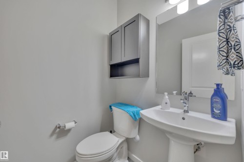 Half bathroom with toilet and a sink - 157 Larch Crescent, Leduc, AB - Indoor Photo Showing Bathroom