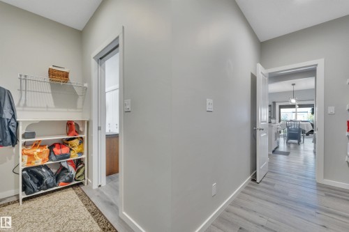 Corridor with light wood-style floors and baseboards - 157 Larch Crescent, Leduc, AB - Indoor Photo Showing Other Room