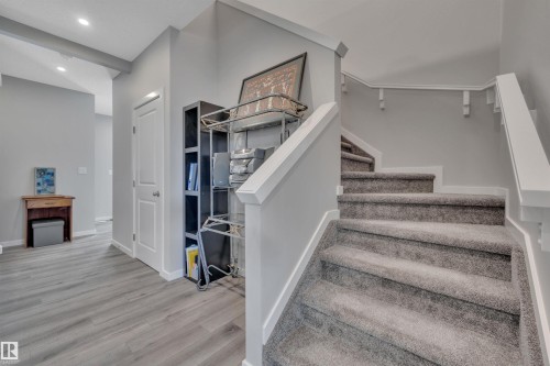 Staircase featuring wood finished floors and recessed lighting - 157 Larch Crescent, Leduc, AB - Indoor Photo Showing Other Room