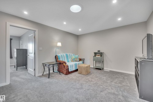 Living area featuring light colored carpet and recessed lighting - 157 Larch Crescent, Leduc, AB - Indoor