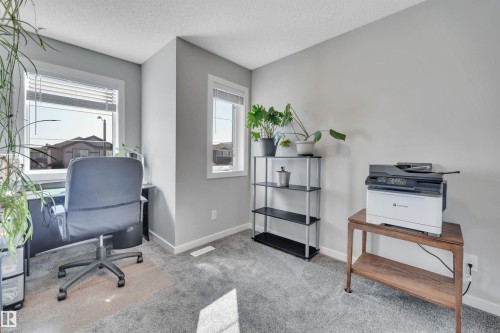Home office featuring light colored carpet and a textured ceiling - 157 Larch Crescent, Leduc, AB - Indoor