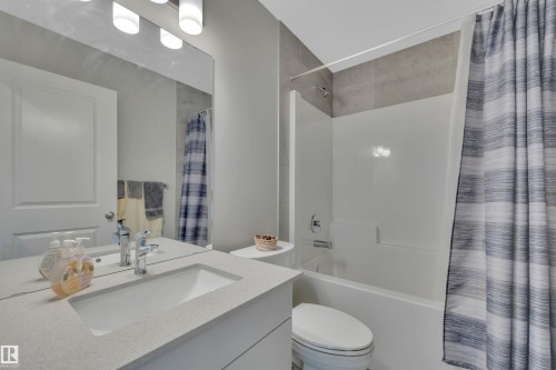 Full bath featuring shower / bathtub combination with curtain and vanity - 157 Larch Crescent, Leduc, AB - Indoor Photo Showing Bathroom