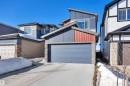 Modern home with stone siding, concrete driveway, an attached garage, and board and batten siding - 157 Larch Crescent, Leduc, AB  - Outdoor 
