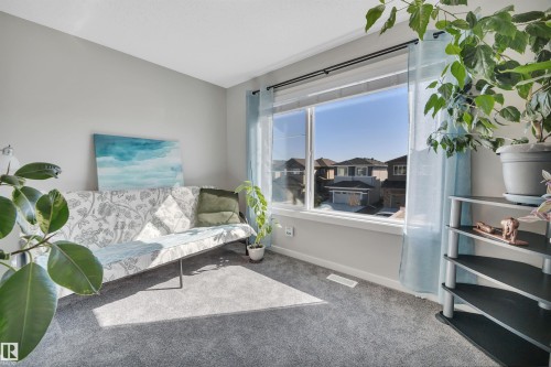 Living area featuring carpet floors and baseboards - 157 Larch Crescent, Leduc, AB - Indoor Photo Showing Bedroom