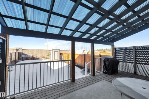 Wooden terrace featuring a storage shed, a fenced backyard, and a grill - 157 Larch Crescent, Leduc, AB - Outdoor With Deck Patio Veranda With Exterior