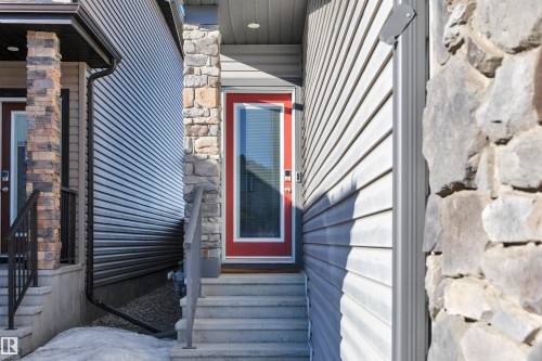 Doorway to property featuring stone siding - 157 Larch Crescent, Leduc, AB - Outdoor With Exterior