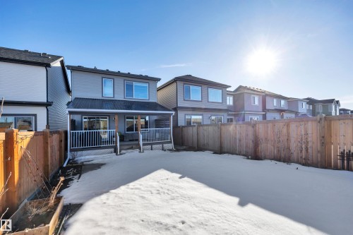Snow covered property with a fenced backyard, a residential view, and a deck - 157 Larch Crescent, Leduc, AB - Outdoor With Deck Patio Veranda
