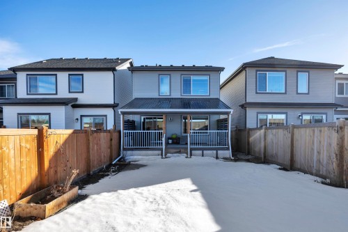 Snow covered property with a fenced backyard and a wooden deck - 157 Larch Crescent, Leduc, AB - Outdoor With Deck Patio Veranda
