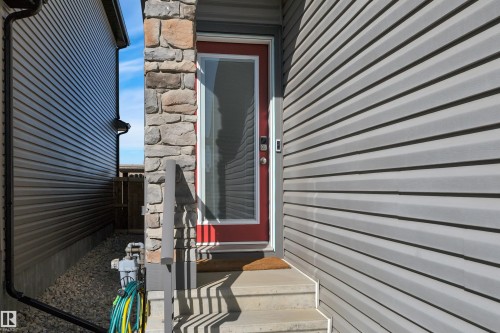 View of exterior entry with stone siding - 157 Larch Crescent, Leduc, AB - Outdoor With Exterior