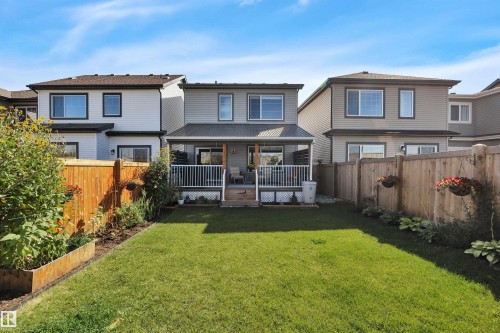 Rear view of house with a fenced backyard - 157 Larch Crescent, Leduc, AB - Outdoor With Deck Patio Veranda